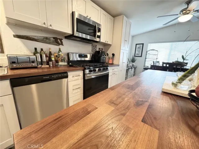 a kitchen with stainless steel appliances granite countertop a sink and stove top oven