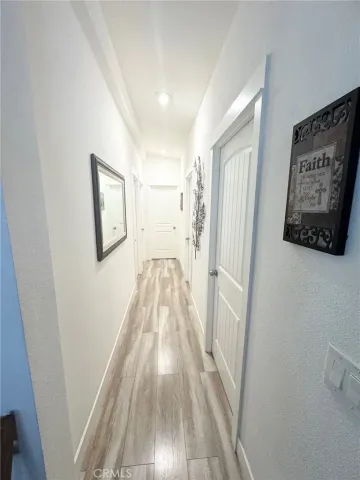 a view of a hallway view with wooden floor and staircase