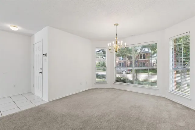 en empty room with windows and fan