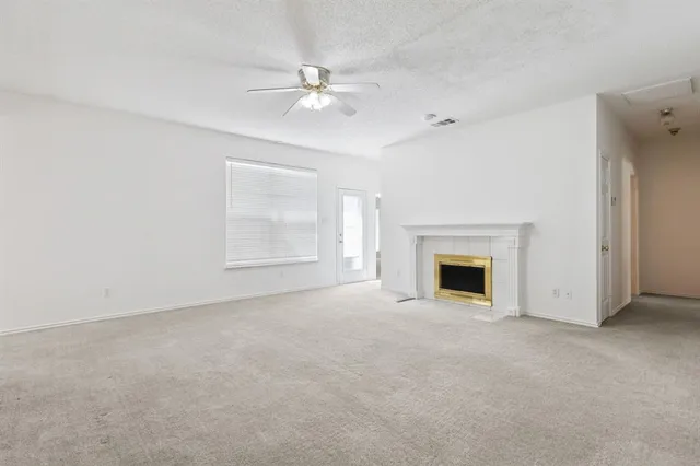 a view of an empty room with a fireplace