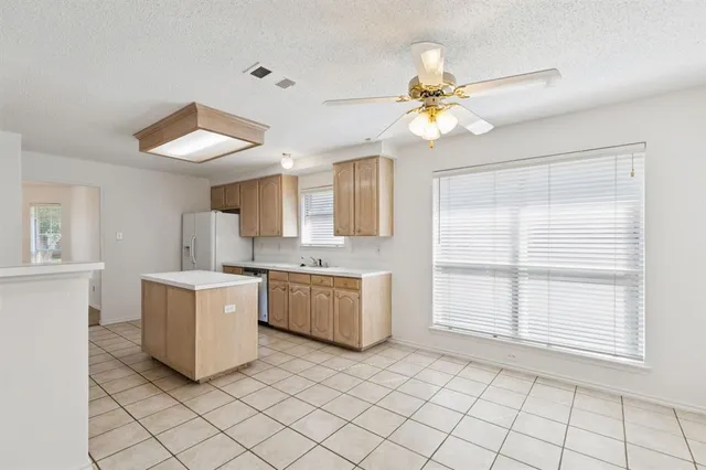 a kitchen with a cabinets and window