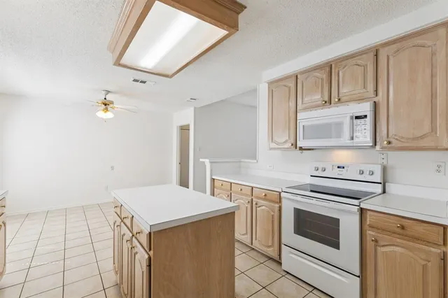 a kitchen that has a sink and a stove in it
