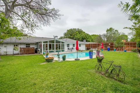 a view of an house with backyard space and sitting area