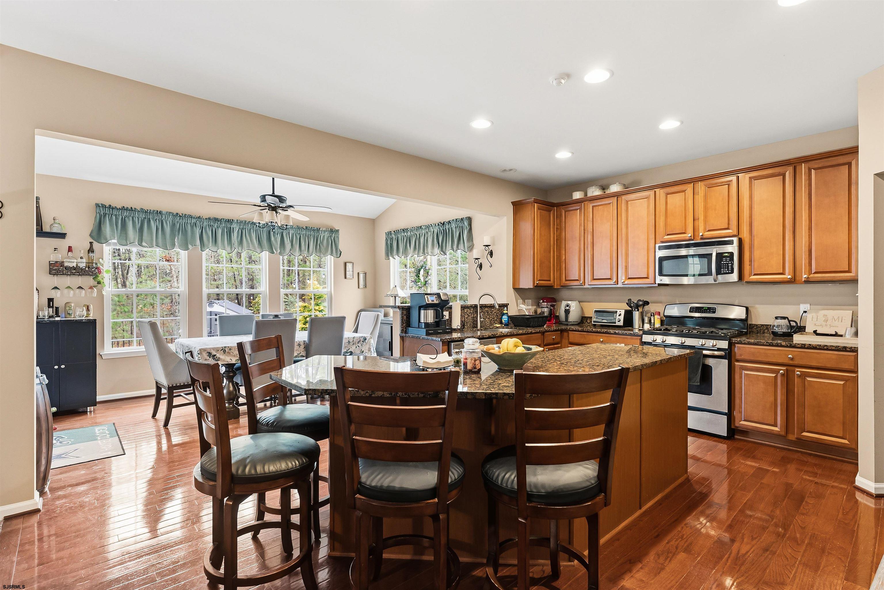 32 Renaissance Drive Mays Landing, NJ 08330 - Photo 12 of 50 a kitchen with a dining table chairs and white appliances
