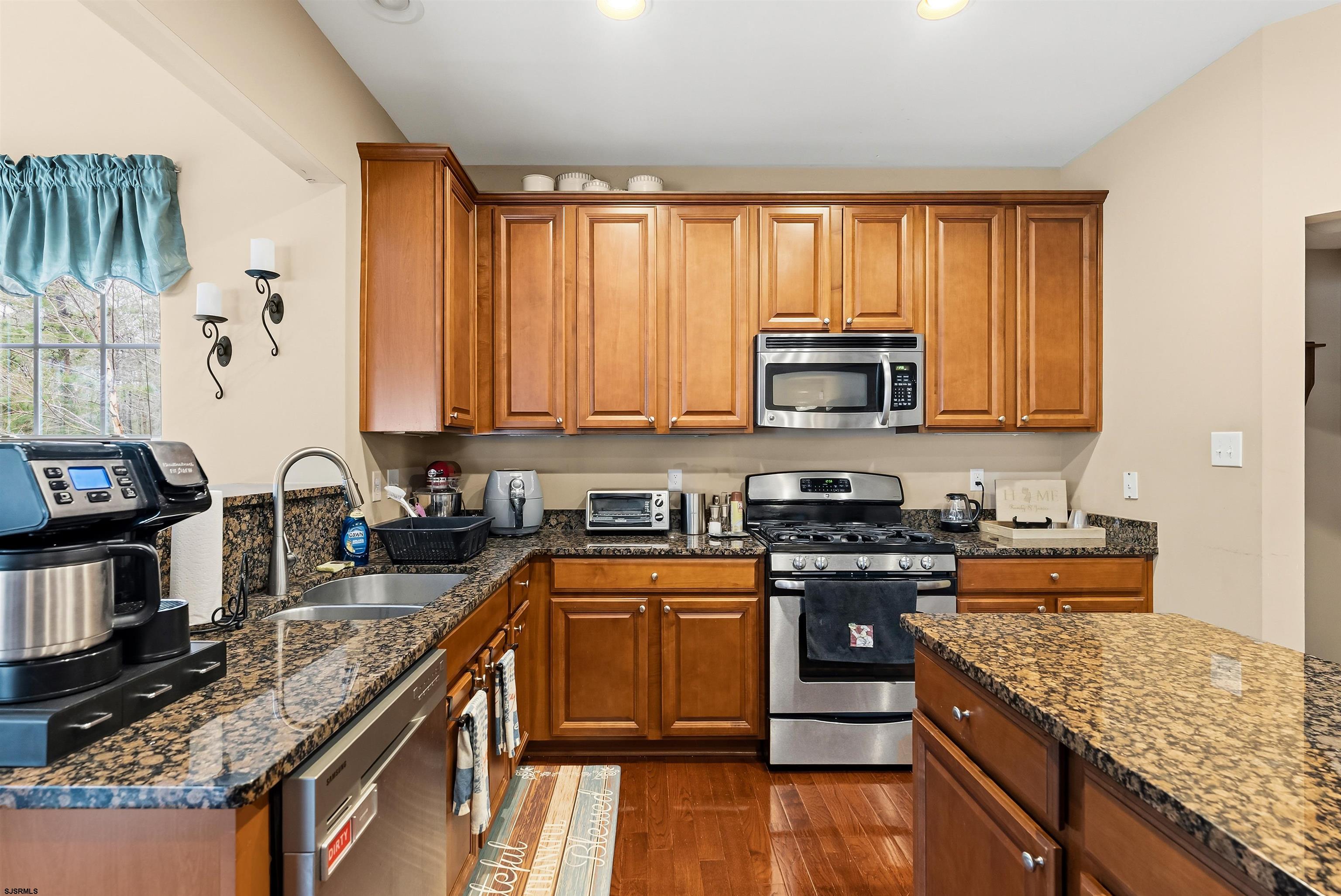 32 Renaissance Drive Mays Landing, NJ 08330 - Photo 13 of 50 a kitchen with stainless steel appliances granite countertop a stove top oven a sink dishwasher and microwave with wooden floor
