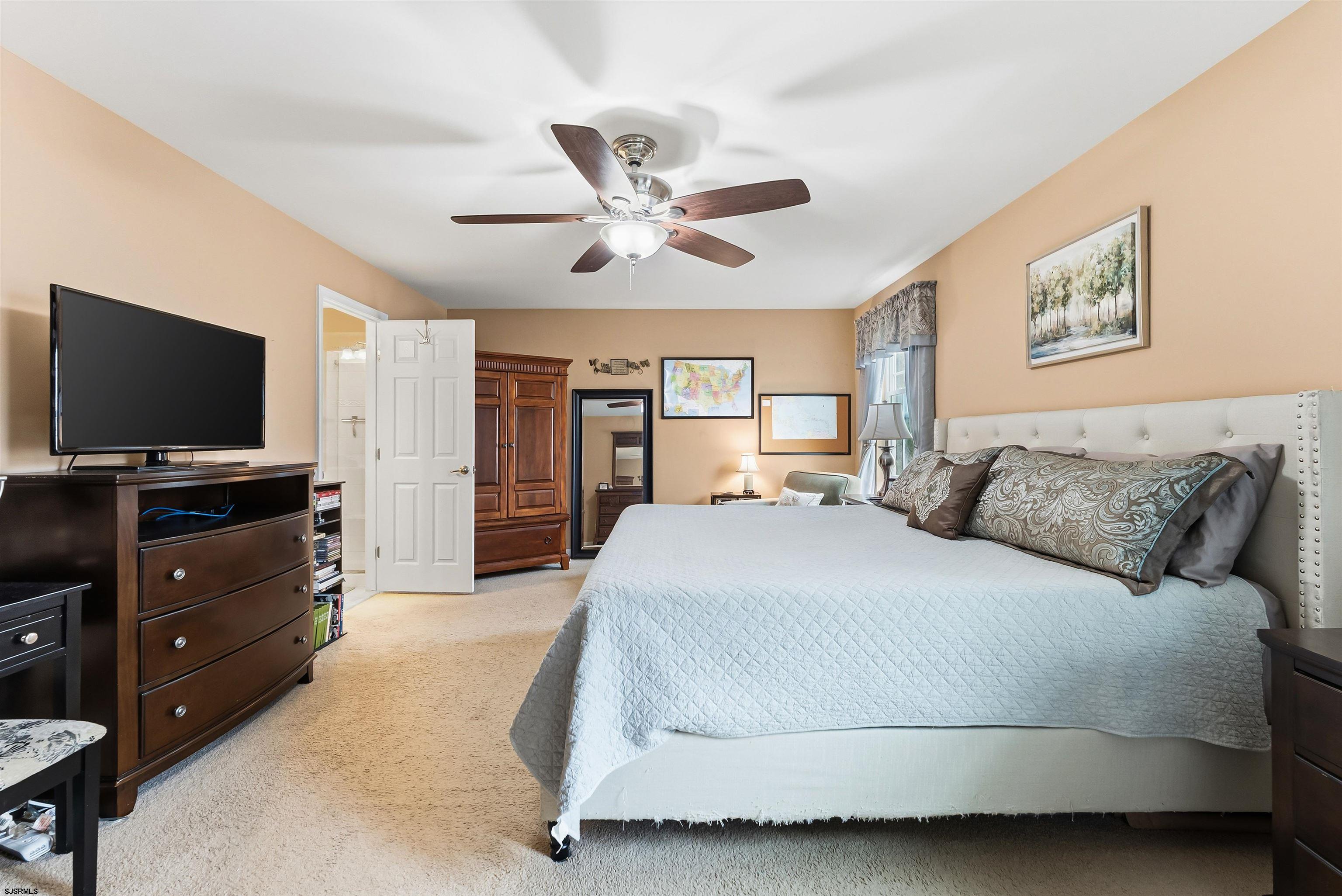 32 Renaissance Drive Mays Landing, NJ 08330 - Photo 32 of 50 a spacious bedroom with a bed and a flat screen tv
