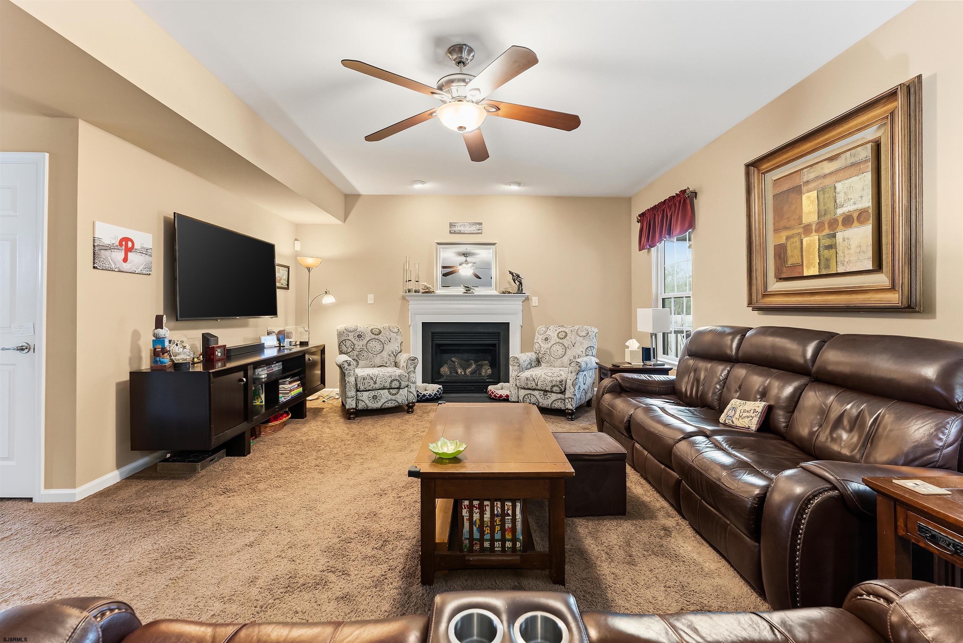 32 Renaissance Drive Mays Landing, NJ 08330 - Photo 7 of 50 a living room with furniture a flat screen tv and a fireplace