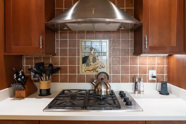 a kitchen with a sink and a stove top oven