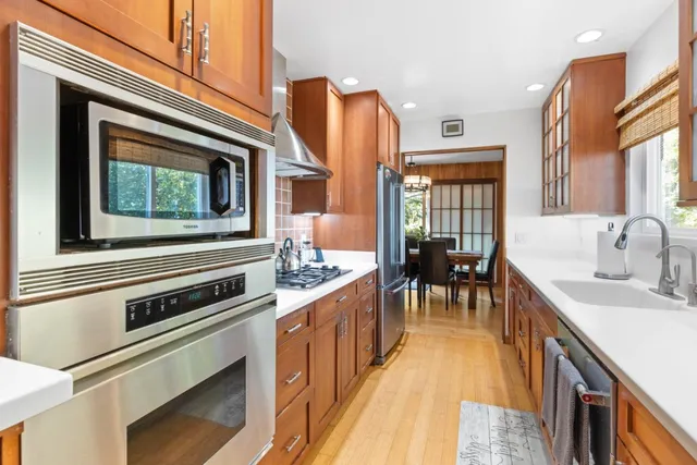 a kitchen with stainless steel appliances granite countertop a stove and a sink
