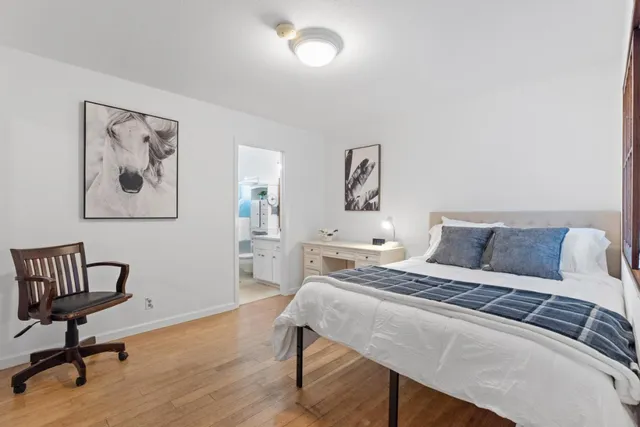 a bedroom with a bed and a desk