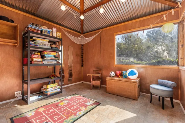 a living room with furniture a rug and a window