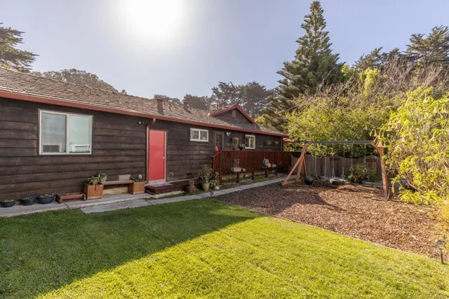 a view of a backyard with table and chairs and wooden fence