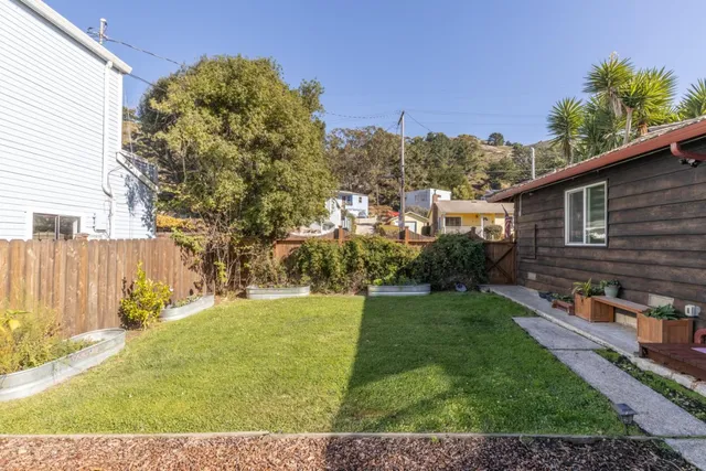 a view of a backyard with plants and a patio