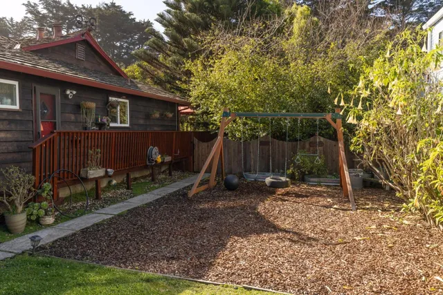 a backyard of a house with barbeque oven table and chairs