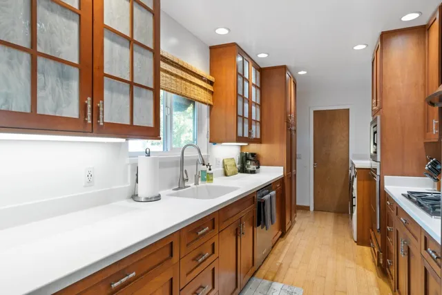 a kitchen with sink and cabinets