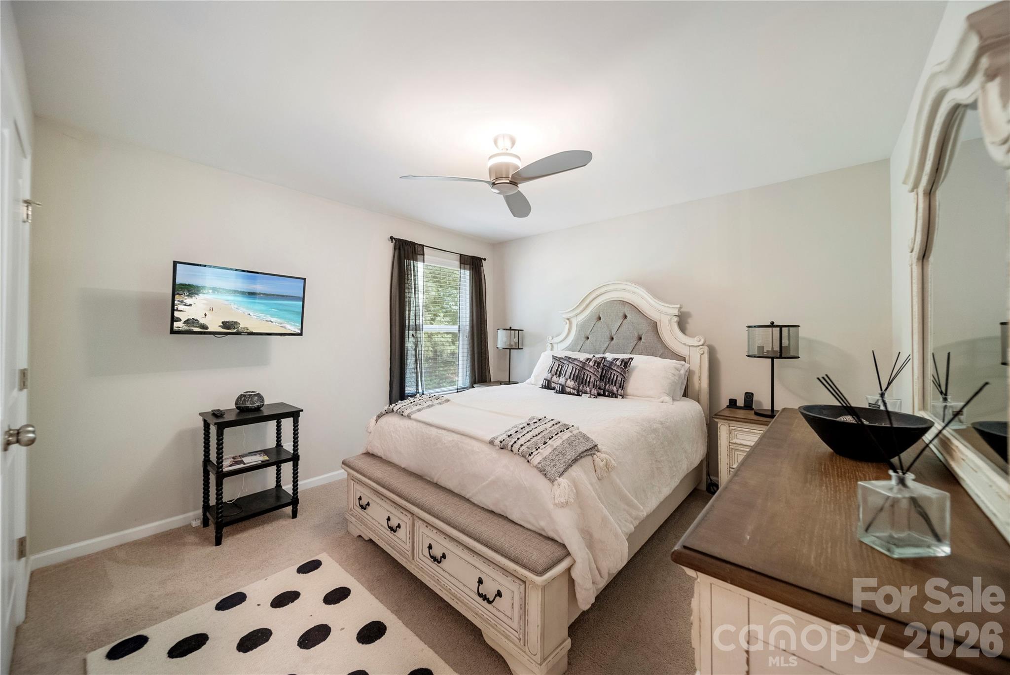 8122 Mossy Rock Road Waxhaw, NC 28173 - Photo 17 of 28 a bedroom with a bed and a chandelier