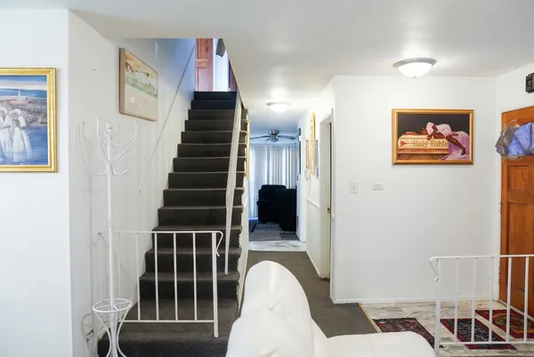 a view of entryway and hall with wooden floor