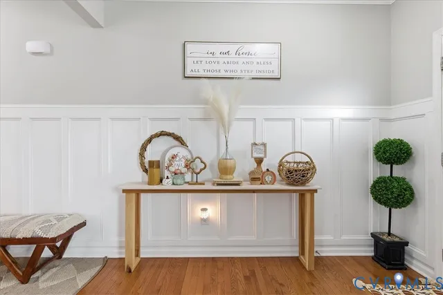 a view of entryway and hall with wooden floor
