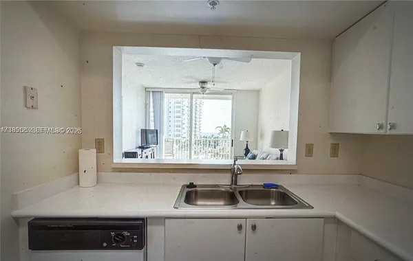 a kitchen with a sink and a window