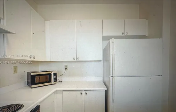 a utility room with cabinets washer and dryer