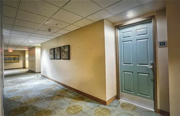 a view of a hallway with wooden floor and glass door
