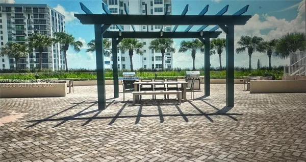 a view of swimming pool with outdoor seating and plants