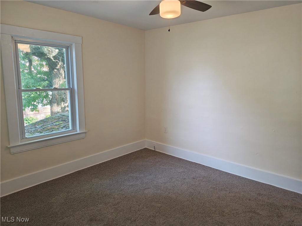 5213 Reed Avenue Ashtabula, OH 44004 - Photo 30 of 35 Spare room featuring dark colored carpet and a ceiling fan