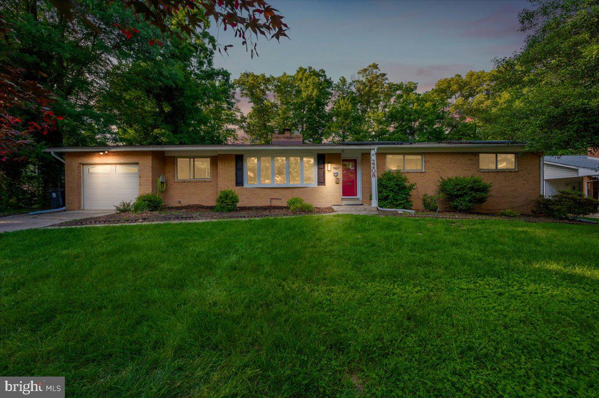 a front view of a house with garden and yard