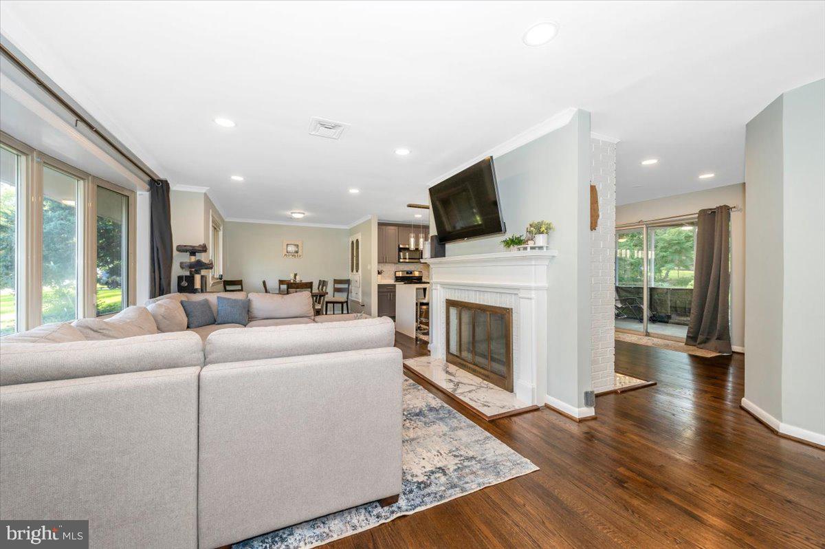 2208 Muskogee Street Adelphi, MD 20783 - Photo 13 of 71 a living room with furniture a fireplace and a flat screen tv