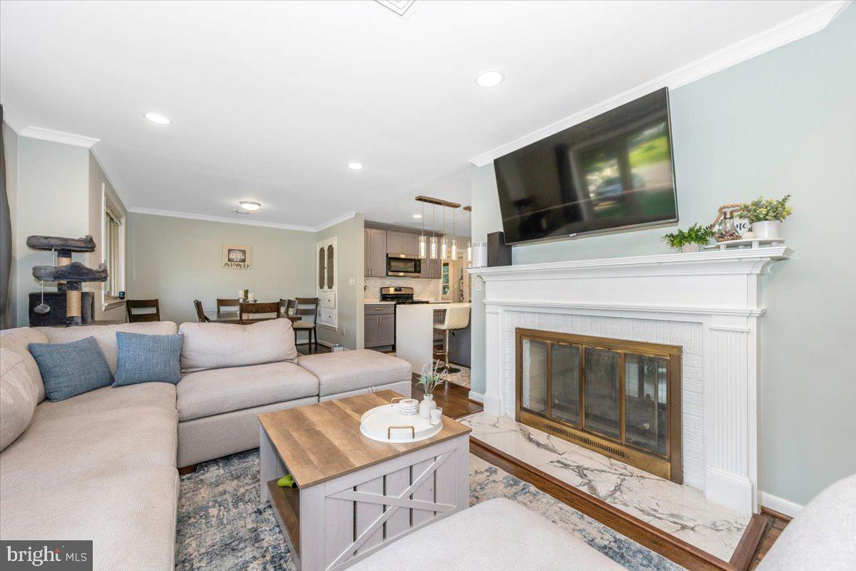 2208 Muskogee Street Adelphi, MD 20783 - Photo 14 of 71 a living room with furniture a flat screen tv and a fireplace