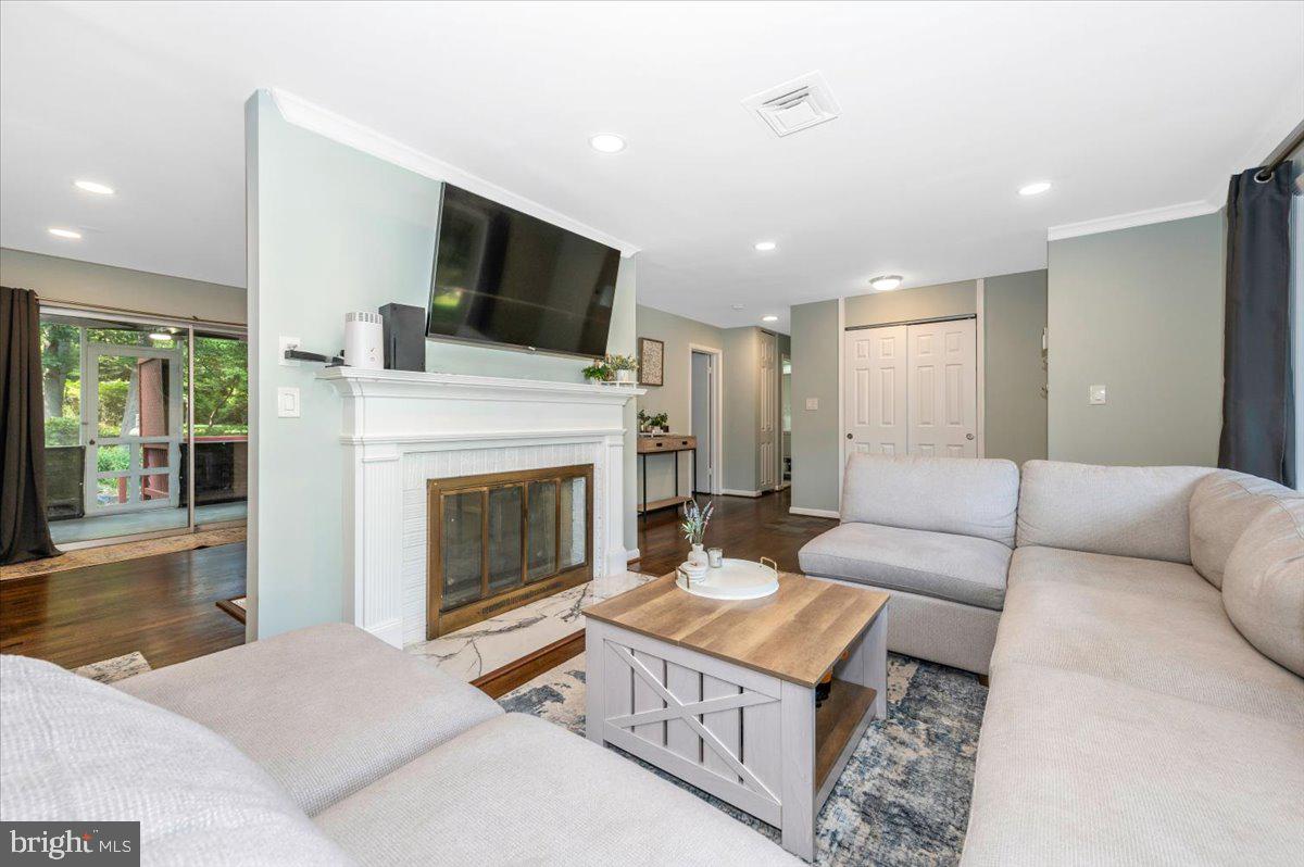2208 Muskogee Street Adelphi, MD 20783 - Photo 16 of 71 a living room with furniture a fireplace and a flat screen tv