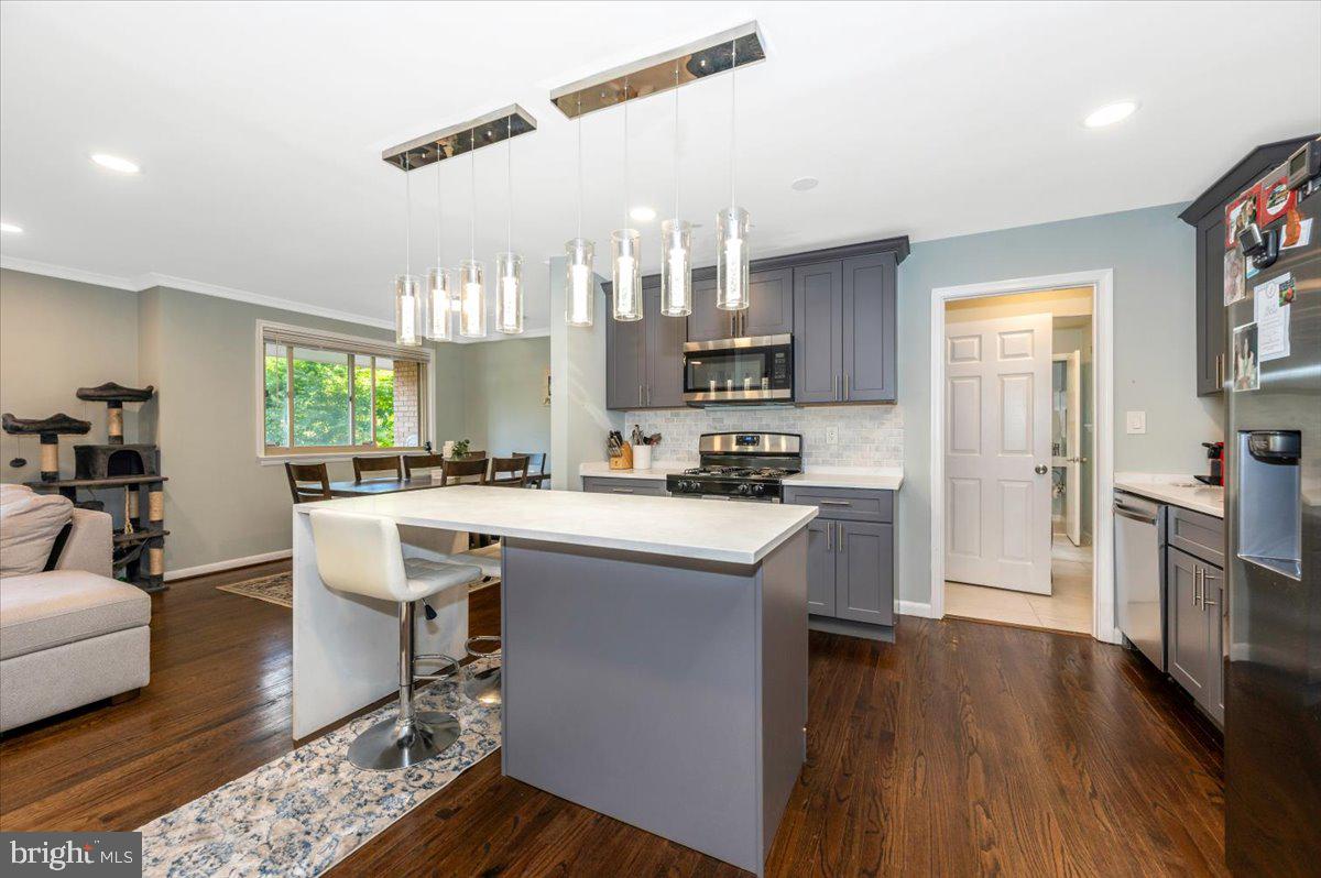 2208 Muskogee Street Adelphi, MD 20783 - Photo 22 of 71 a kitchen with stainless steel appliances granite countertop a refrigerator a stove top oven a sink dishwasher and white cabinets with wooden floor
