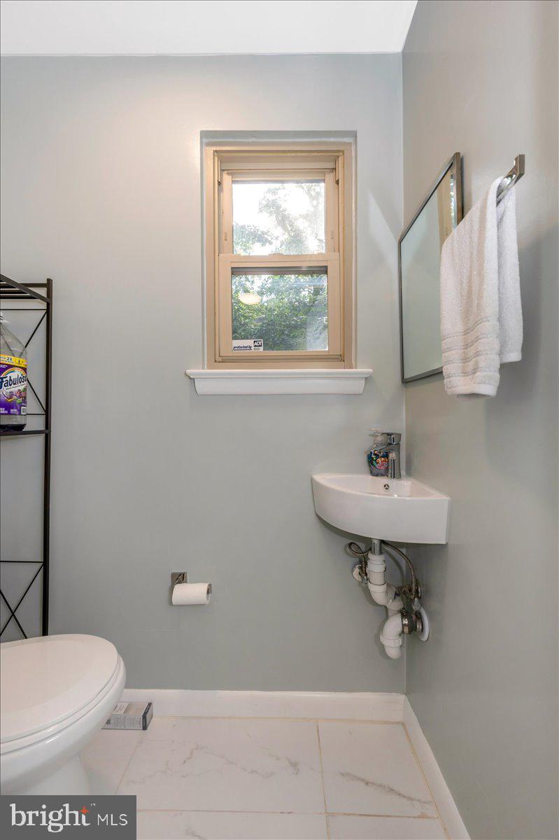 2208 Muskogee Street Adelphi, MD 20783 - Photo 32 of 71 a bathroom with a sink toilet and a window