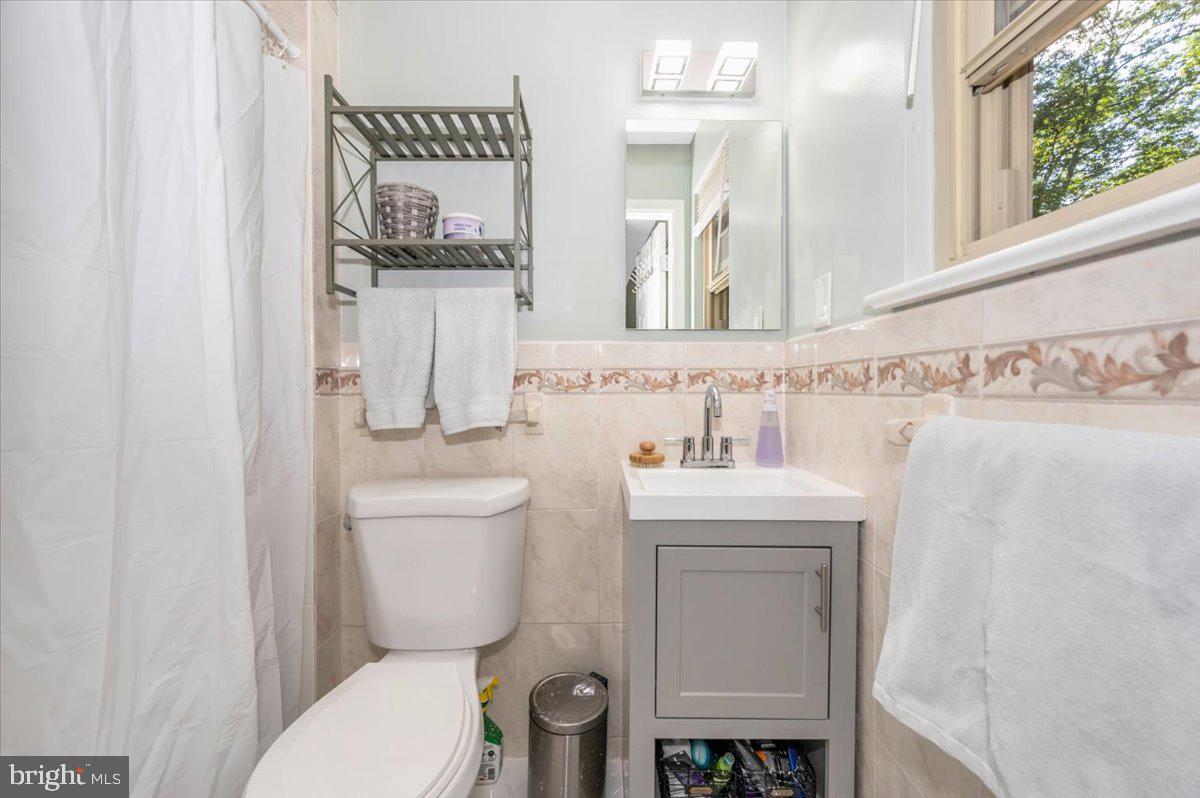 2208 Muskogee Street Adelphi, MD 20783 - Photo 35 of 71 a bathroom with a toilet sink and mirror