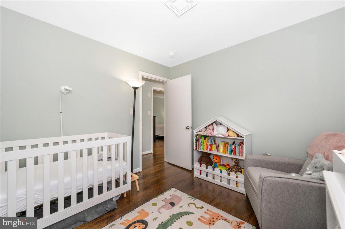 2208 Muskogee Street Adelphi, MD 20783 - Photo 39 of 71 a living room with baby crib and a wooden floor