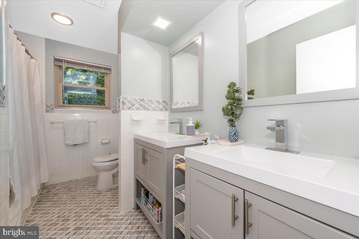 2208 Muskogee Street Adelphi, MD 20783 - Photo 40 of 71 a bathroom with a sink a toilet and a mirror