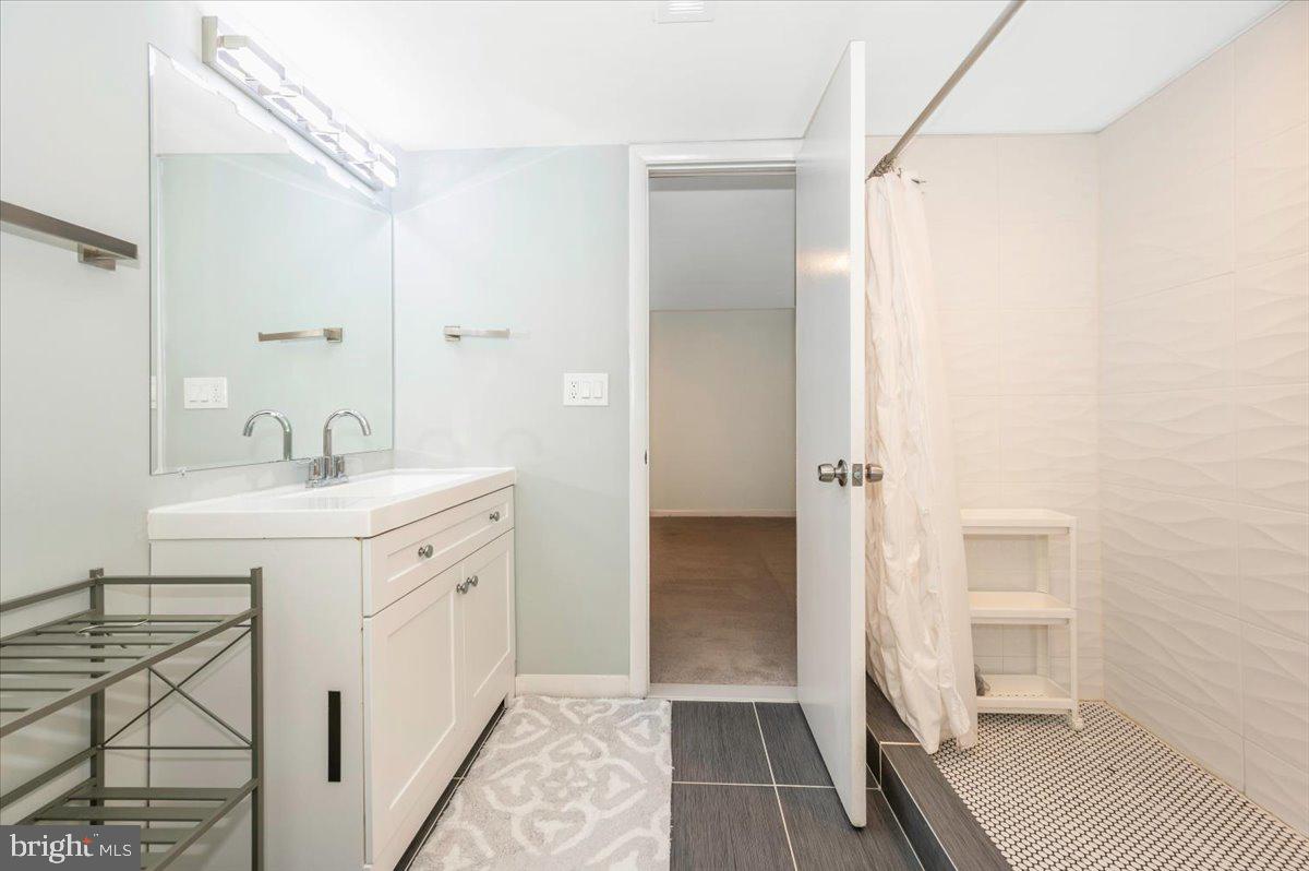 2208 Muskogee Street Adelphi, MD 20783 - Photo 47 of 71 a spacious bathroom with a shower sink and a toilet