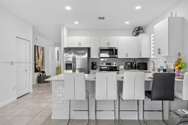 a kitchen with stainless steel appliances a refrigerator and microwave
