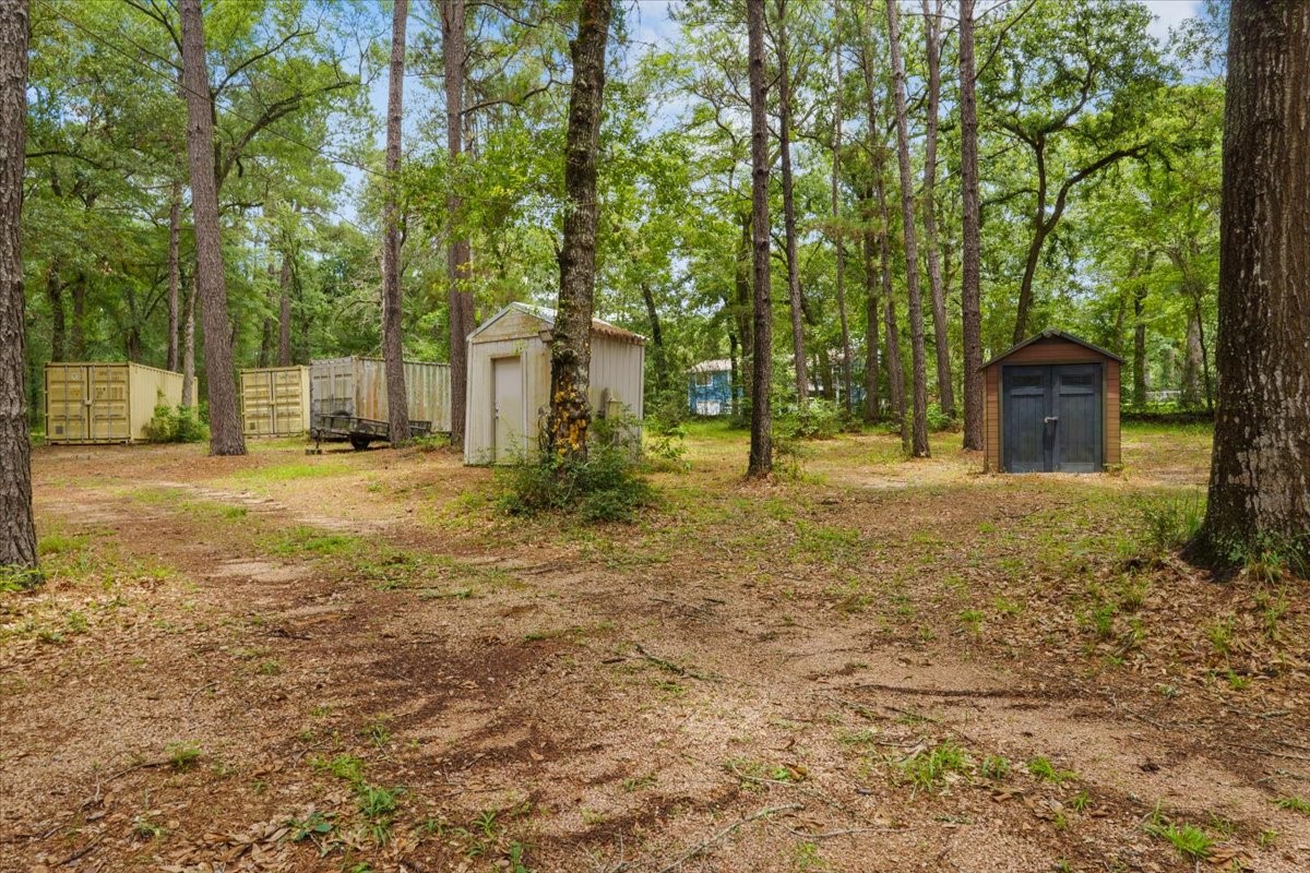 16375 Grand Flower Road Plantersville, TX 77363 - Photo 37 of 50 a house with trees in front of it