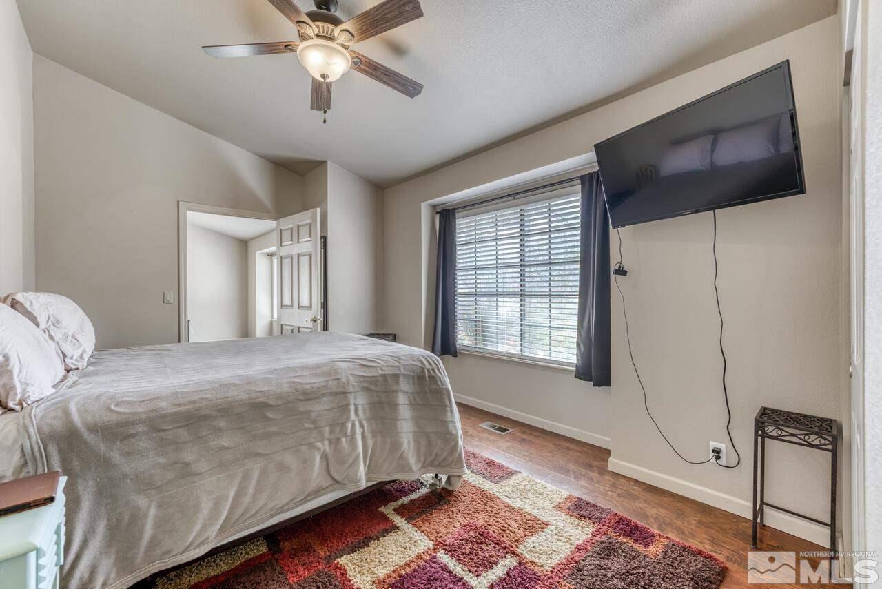 5325 Mountcrest Lane Reno, NV 89523 - Photo 14 of 17 a bedroom with a bed and a chandelier