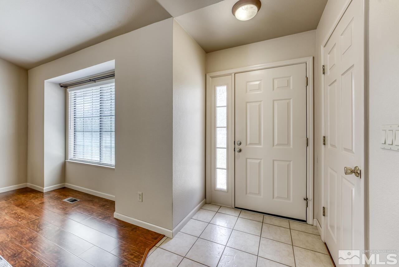 5325 Mountcrest Lane Reno, NV 89523 - Photo 2 of 17 an empty room with wooden floor and windows