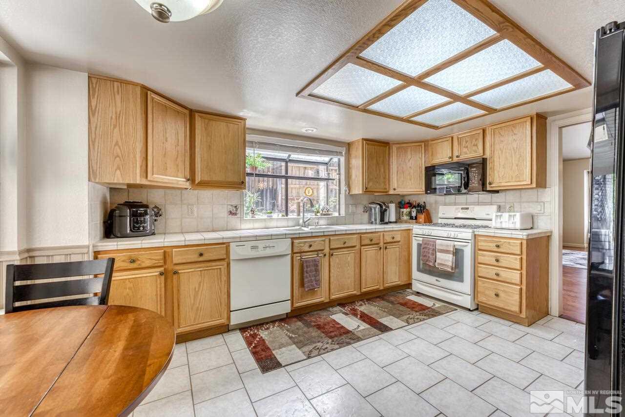 5325 Mountcrest Lane Reno, NV 89523 - Photo 6 of 17 a kitchen with a stove a sink dishwasher a refrigerator and a microwave oven