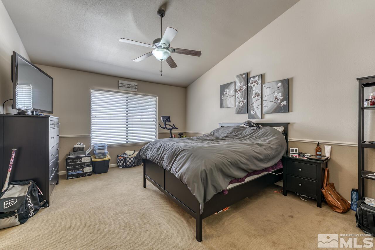 5325 Mountcrest Lane Reno, NV 89523 - Photo 9 of 17 a spacious bedroom with a bed and a desk