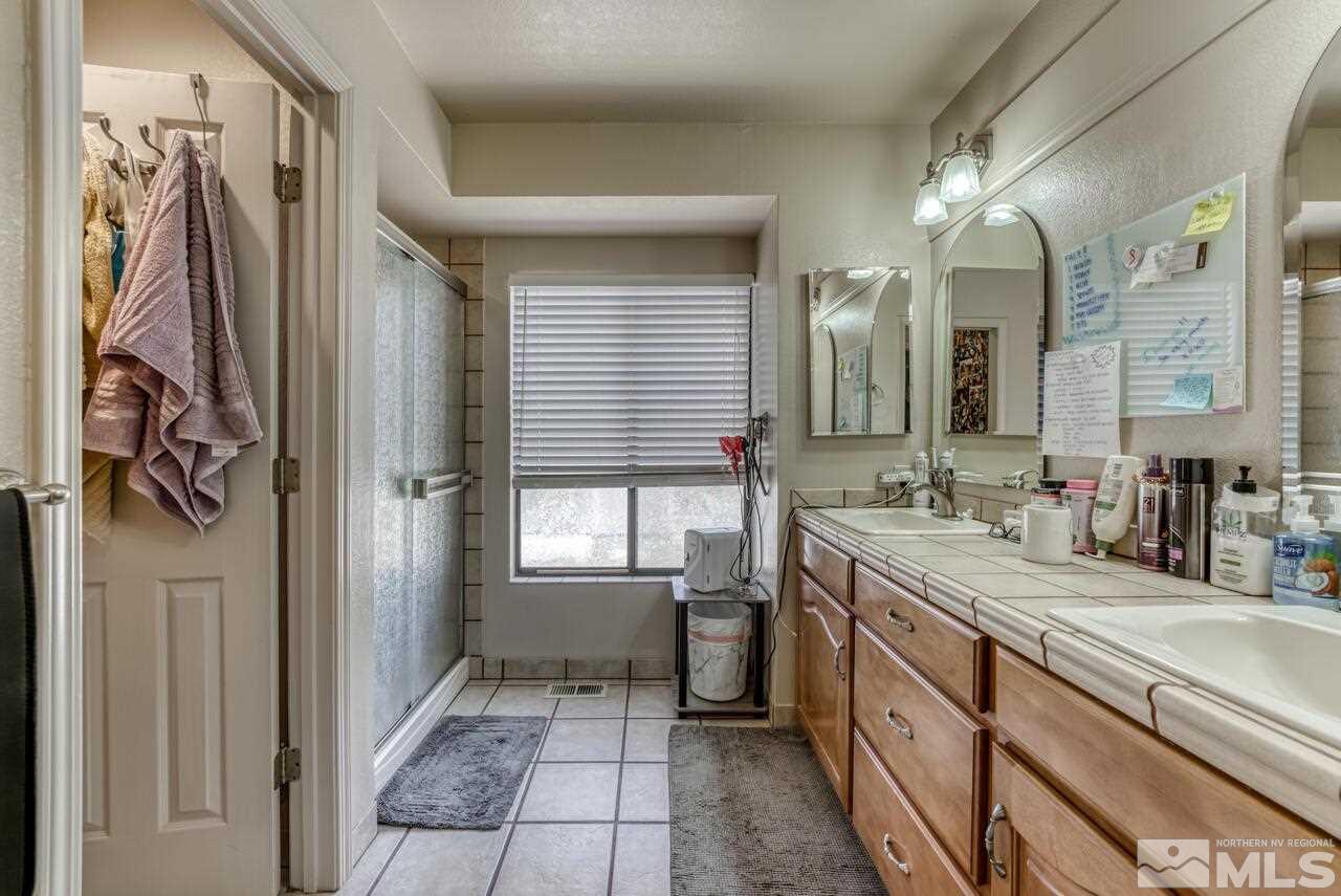 5325 Mountcrest Lane Reno, NV 89523 - Photo 10 of 17 a bathroom with a double vanity sink and a mirror