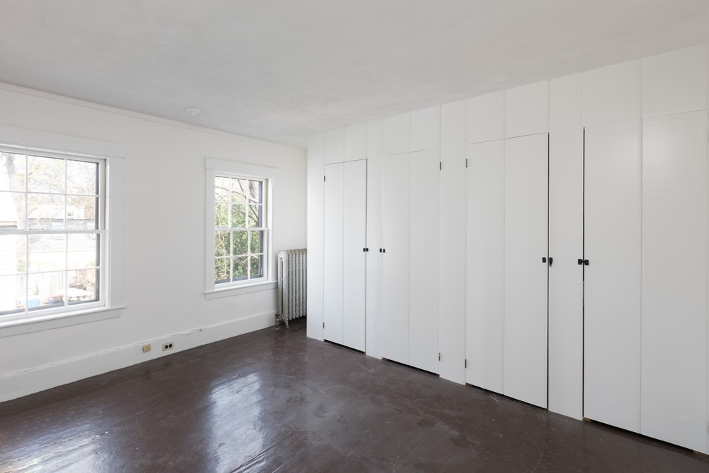 12 Farwell Place, Unit 12 Cambridge, MA 02138 - Photo 12 of 17 a view of an empty room with wooden floor and a window