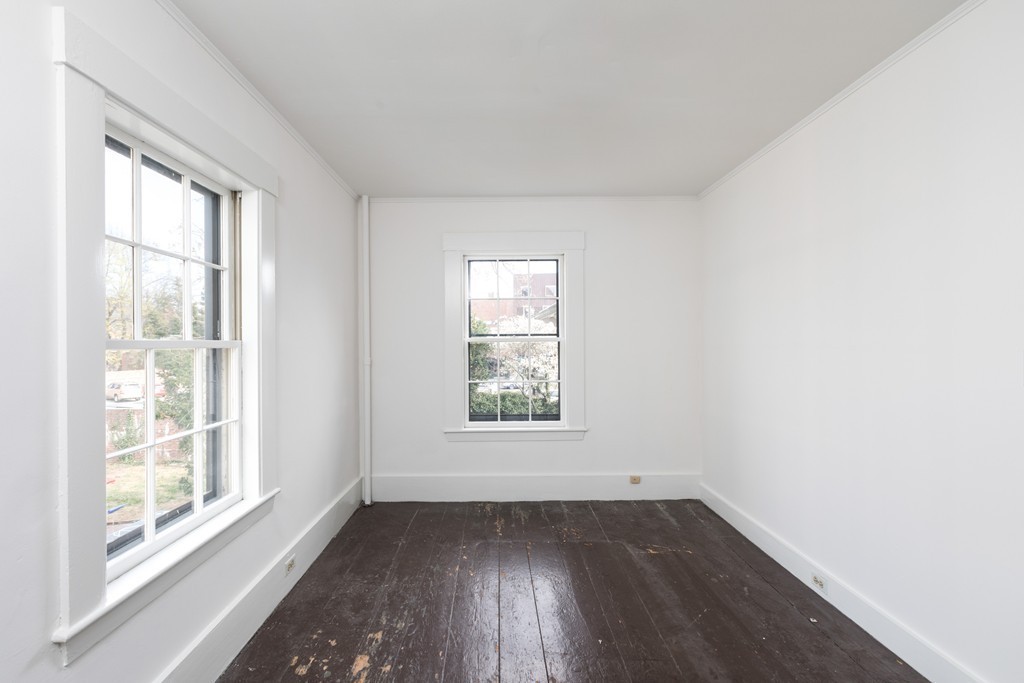 12 Farwell Place, Unit 12 Cambridge, MA 02138 - Photo 13 of 17 an empty room with wooden floor and windows