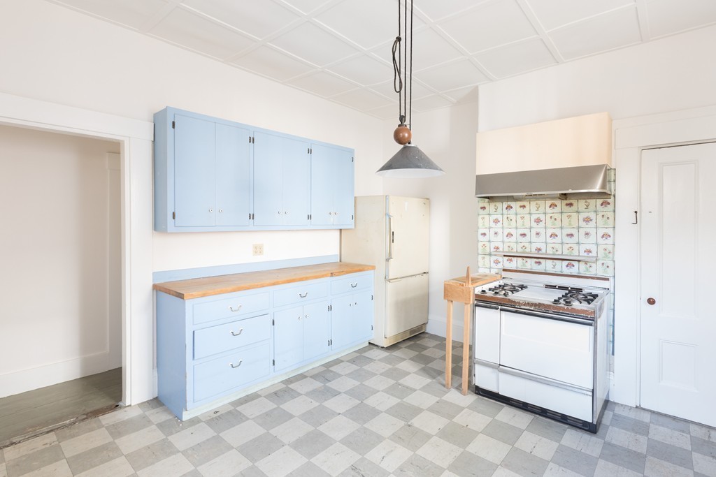 12 Farwell Place, Unit 12 Cambridge, MA 02138 - Photo 4 of 17 a kitchen with granite countertop white cabinets and white appliances