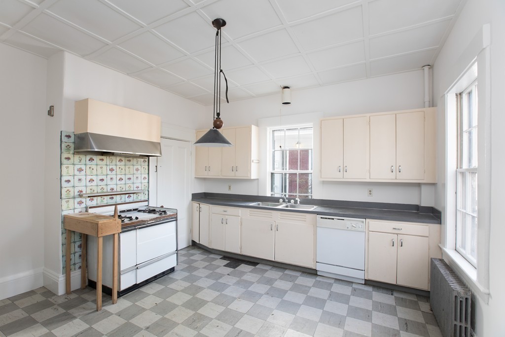12 Farwell Place, Unit 12 Cambridge, MA 02138 - Photo 6 of 17 a kitchen with granite countertop white cabinets white stainless steel appliances with a sink and dishwasher