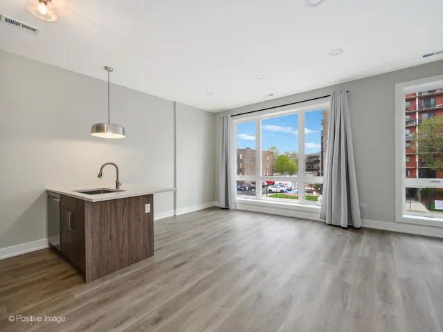 a view of a room with wooden floor and window