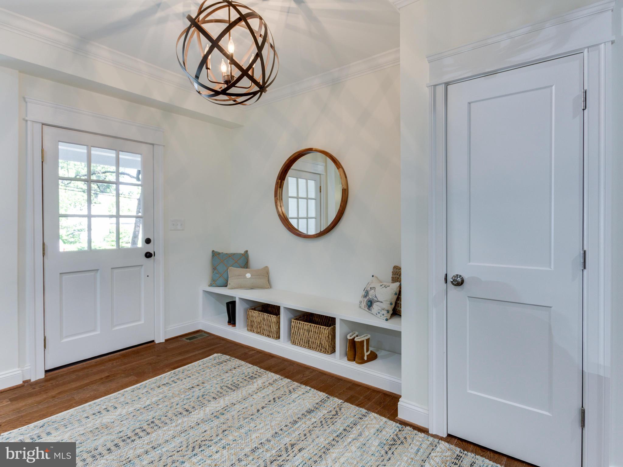 a view of a hallway with wooden floor and a potted plant